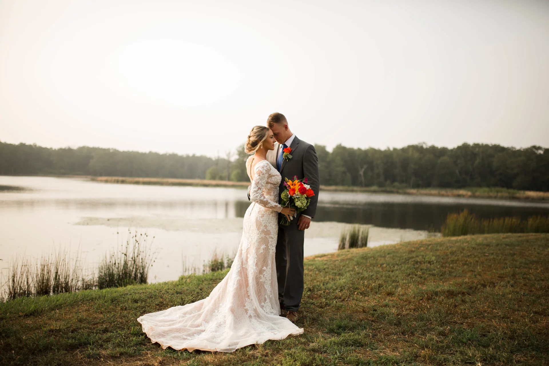 Bride and groom sharing a quiet moment by a lake at sunset, Fort Worth area wedding photography