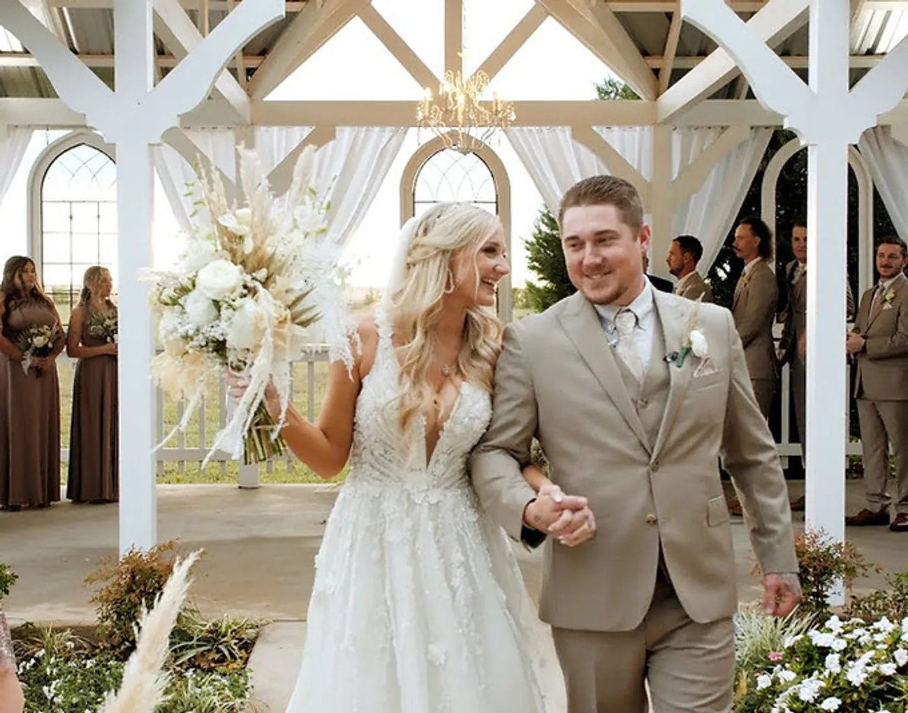 Kenzie and JJ walking with their wedding party after the ceremony, filmed by Constantine Films