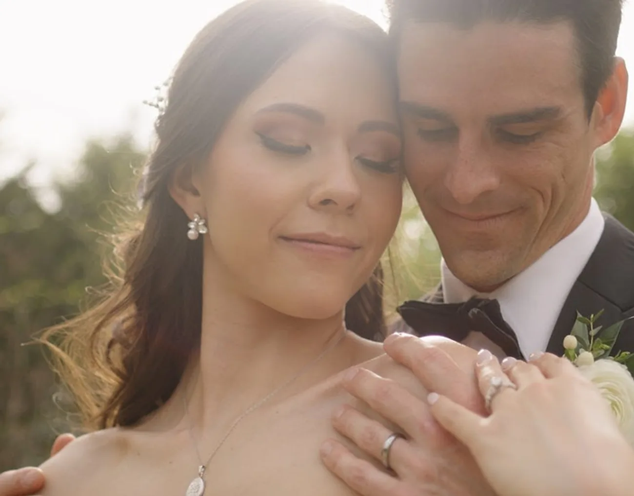 Sofia and Greg share an intimate embrace at golden hour, filmed by Constantine Films